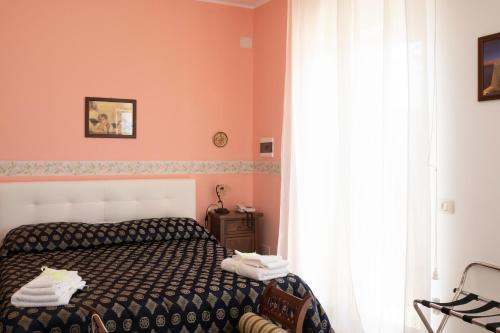 sypialnia z łóżkiem i oknem w obiekcie Villa Catalano w mieście Paola