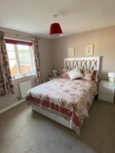 a bedroom with a bed and a window at Flint Lodge in Peacehaven