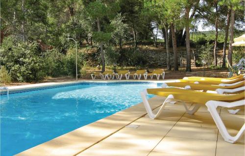 a swimming pool with lounge chairs and a swimming pool at Pet Friendly Home In Cesseras With Outdoor Swimming Pool in Cesseras