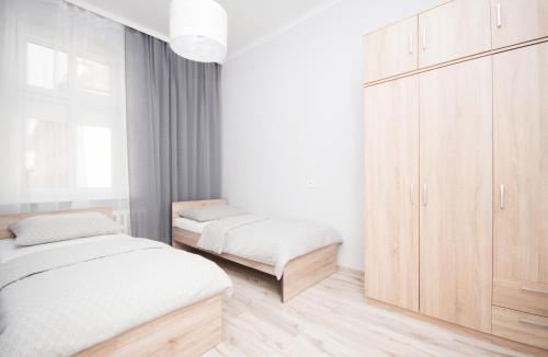 Postel nebo postele na pokoji v ubytování Apartament Marysia Sławno