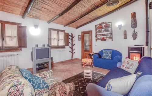 a living room with blue couches and a tv at Villa Antonietta in Oliena