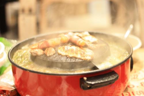 a pot with food cooking in it on a stove at Wan Resort Rayong in Ban Laem Makham