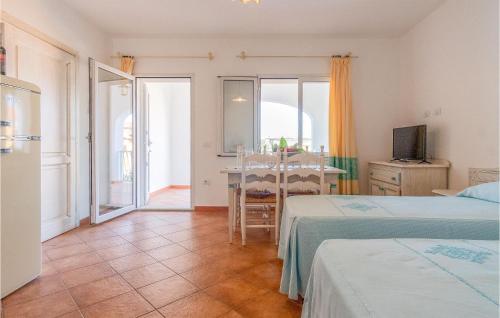 a room with two beds and a table with a television at Bilo 4 in Orosei