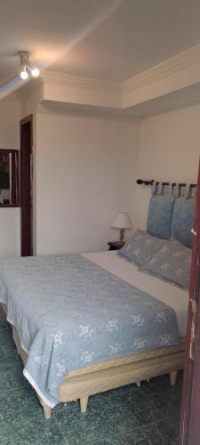 a bedroom with a large bed in a room at Hotel Pousada Laje de Itauna in Saquarema