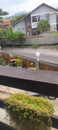 a view of a house from a balcony with plants at Hotel Pousada Laje de Itauna in Saquarema