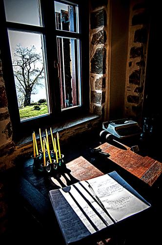 a group of knives sitting on a table next to a window at Hotel Maistra in Tsagarada