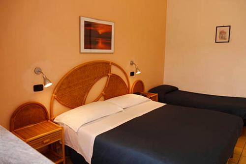a bedroom with a bed and a couch at Hotel Residence La Darsena in Agropoli