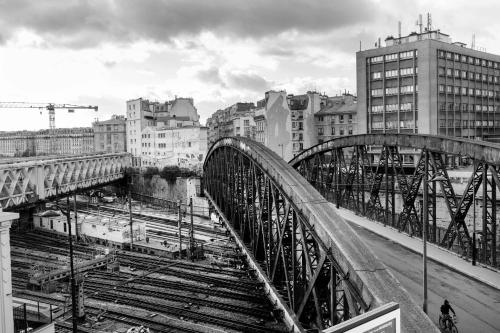 a black and white photo of a bridge in a city at Hotel de l'Aqueduc in Paris