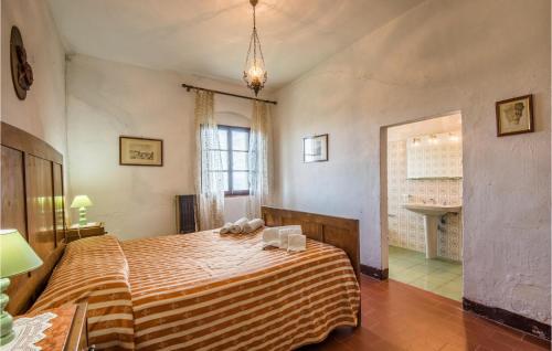a bedroom with a large bed with a striped blanket at Travicello 1 in Gambassi Terme