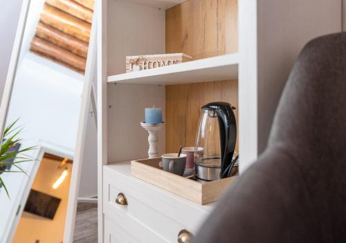 a cupboard with a tea kettle and cups on it at Lotza Traditional House Salakos in Sálakos