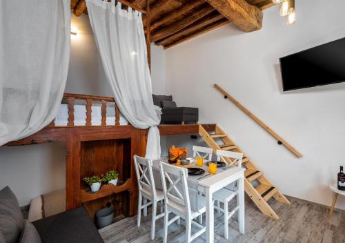 a living room with a white table and chairs at Lotza Traditional House Salakos in Sálakos