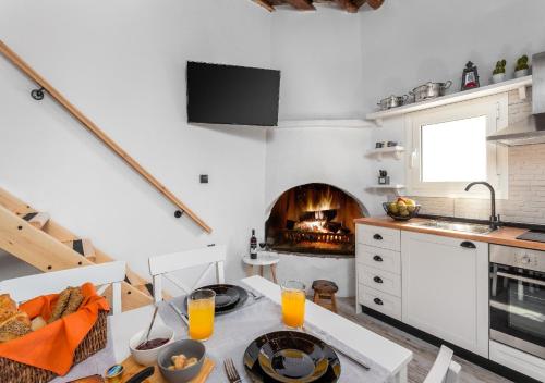 a kitchen with a table and a fireplace at Lotza Traditional House Salakos in Sálakos