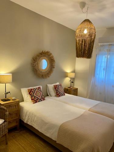 a bedroom with a large bed and a mirror at Monte da Aparica in Galeguinha Grande