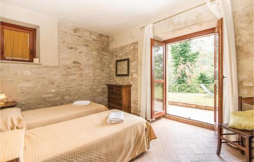 a bedroom with two beds and a large window at Collonico in Stroncone