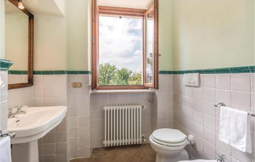 a bathroom with a toilet and a sink and a window at Collonico in Stroncone