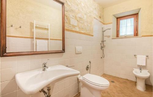a bathroom with a sink and a toilet and a mirror at Collonico in Stroncone
