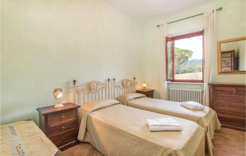 a bedroom with two beds and a window at Collonico in Stroncone