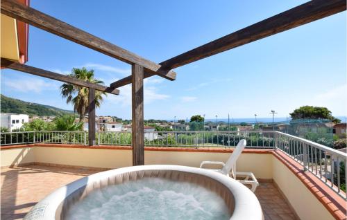 a hot tub on the balcony of a house at Stunning Home In Sangineto Lido in Belvedere Marittimo