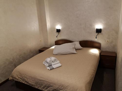 a bedroom with a bed with towels on it at Pas Nerijų in Skuodas