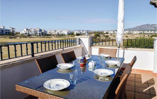 a blue table with plates and glasses on a balcony at Beautiful Apartment In Sucina With Wifi in Sucina