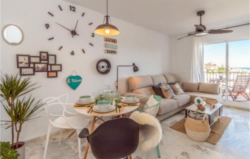 a living room with a table and a couch at Stunning Apartment In Mijas Costa in Mijas Costa