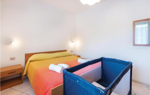 a small bedroom with a bed with a blue box at Casa Sole Rosso in Buggerru