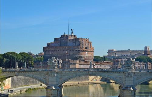 a bridge over a river in front of a building at Carlotta in Grottaferrata