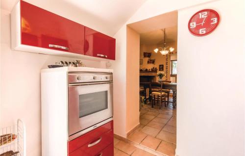 a kitchen with a stove and a clock on the wall at Quadrifoglio in Configni
