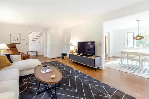 a living room with a couch and a tv at Wellfleet Harbor Hideaway in Wellfleet