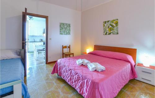 ein Schlafzimmer mit einem rosa Bett mit Handtüchern darauf in der Unterkunft La Casa Sul Mare in Trappeto