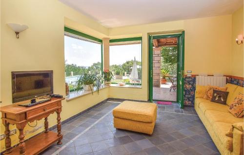 a living room with a couch and a tv at Villa Agata in Latera