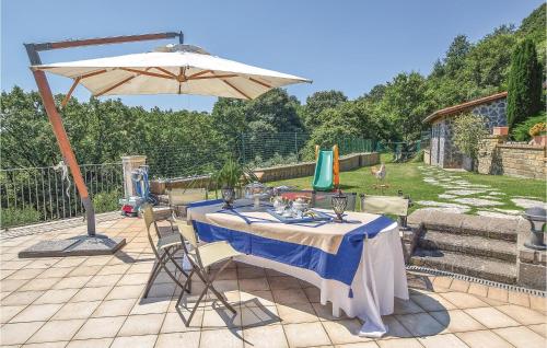 a table with an umbrella on a patio at Villa Agata in Latera