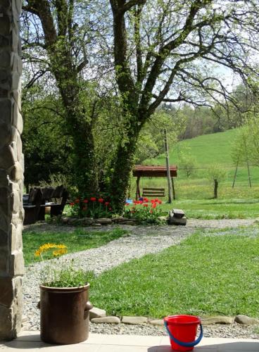 a garden with a park with a bench and flowers at Podołynia in Dwernik