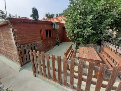 a wooden patio with a wooden table and a fence at Parco Gessilandia in Sassofeltrio