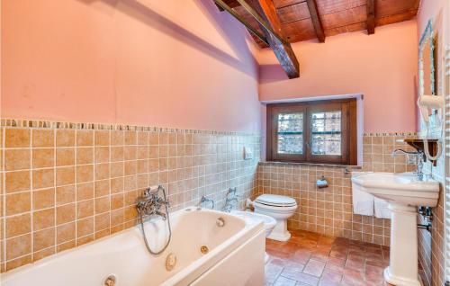a bathroom with a tub and a toilet and a sink at Cinque Querci, Lucignano in Pieve Vecchia