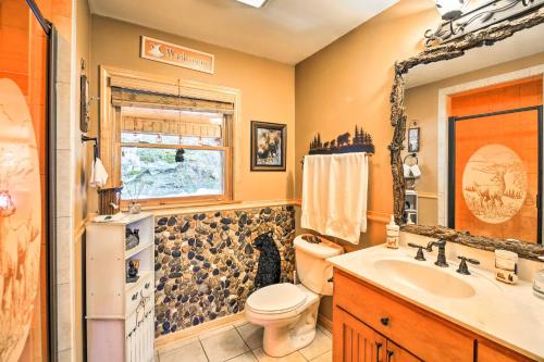 a bathroom with a toilet and a sink at 'River Dream Cabin' on New River w/ Fire Pit in Piney Creek