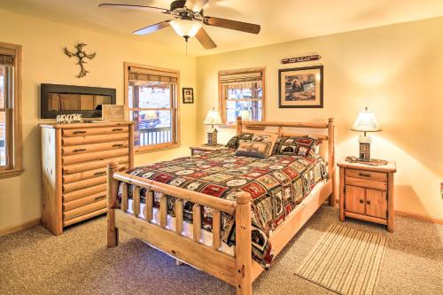 a bedroom with a bed and a dresser and a tv at 'River Dream Cabin' on New River w/ Fire Pit in Piney Creek