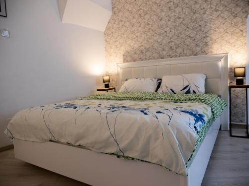 a bedroom with a white bed with pillows at Melion Historical Center Apartment in Sibiu