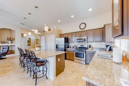 a kitchen with a large island with bar stools at Bedrock Lane in Oro Valley