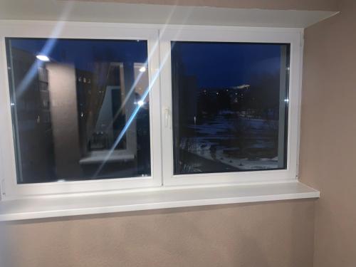 a window with a view of a city at night at K76 - Very Nice 2-bedrooms Apartment -2 big beds-1 single bed in Tartu