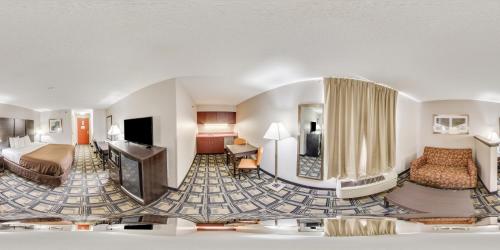a hotel room with a bed and a television at Suburban Studios Mason Hwy 42 in Mason