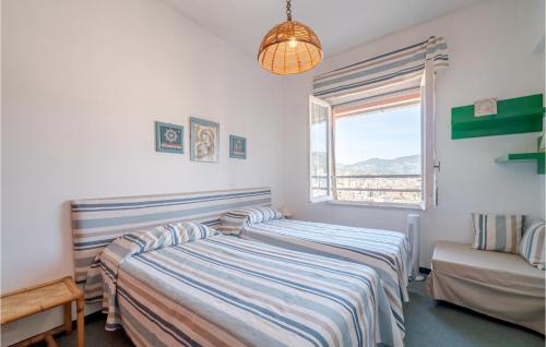 two beds in a room with a window at Casa Zigoela in Rapallo