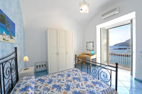 a bedroom with a bed and a view of the ocean at Dolce Vita A in Amalfi