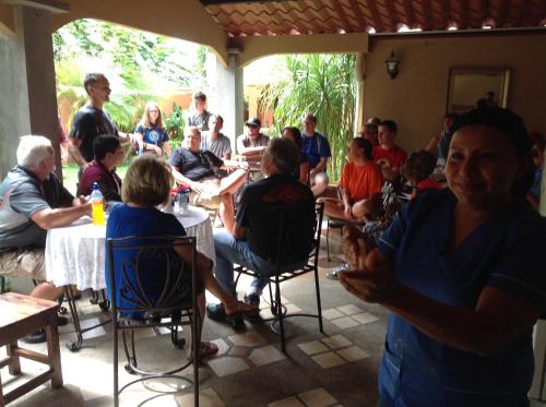 a group of people sitting at tables in a room at Hotel Santa Maria Inn in Alajuela City