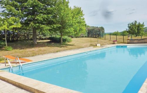a large blue swimming pool with trees in the background at 3 Bedroom Cozy Home In Sault in Sault-de-Vaucluse