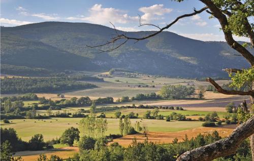 a view of a field with mountains in the background at 3 Bedroom Cozy Home In Sault in Sault-de-Vaucluse