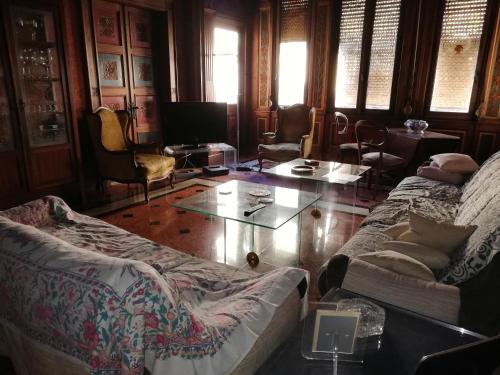 a living room with two couches and a glass table at Le Stanze del Notaio in Genova