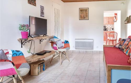a living room with a couch and a tv at Stunning Home In St Avaugourd Des Lande in Saint-Avaugourd-des-Landes