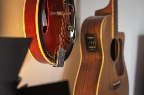 a close up of a guitar hanging on a wall at Milos Guesthouse in Triovasálos