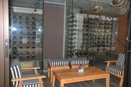 a room with tables and chairs and wine bottles at Cozy Stays Cayala Apartments 5 in Guatemala